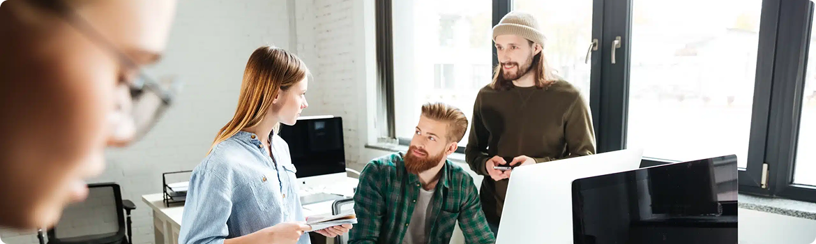 Web developers discussing a project in a modern office space