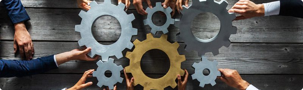 Hands of multiple people holding interlocking gears to represent software and payment integration collaboration